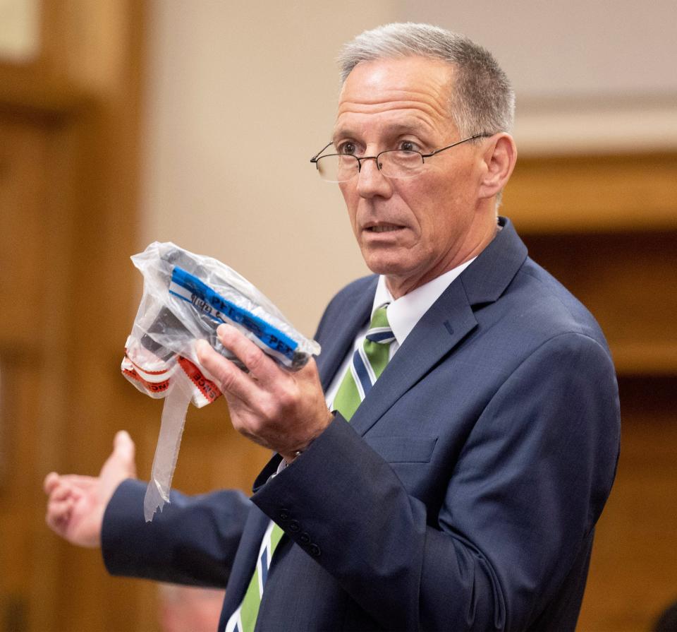Dennis Barr, chief of the criminal division in the Stark County Prosecutor's Office, holds the gun he said Jamaari Harper used to fatally shoot Garry Marx Jr. on Feb. 6. Harper's trial concluded Wednesday with guilty verdicts on charges of murder, felonious assault and aggravated robbery in Stark County Common Pleas Court.