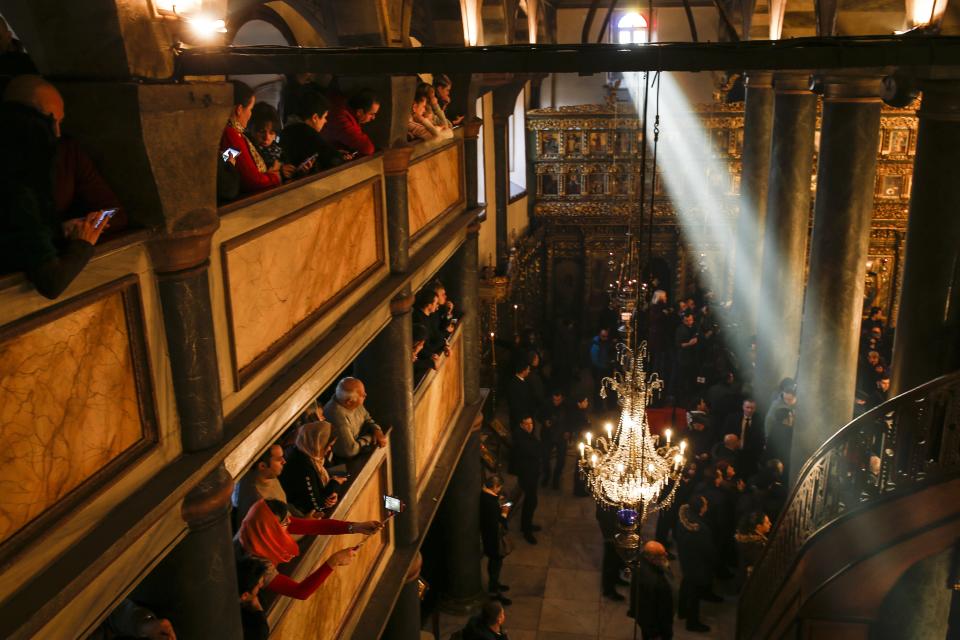 Visitors wait for a religion service at the Patriarchal Church of St. George in Istanbul, Sunday, Jan. 6, 2019. An independent Ukrainian Orthodox church has been created at a signing ceremony in Turkey, formalizing a split with the Russian church it had been tied to since 1686. (AP Photo/Emrah Gurel)