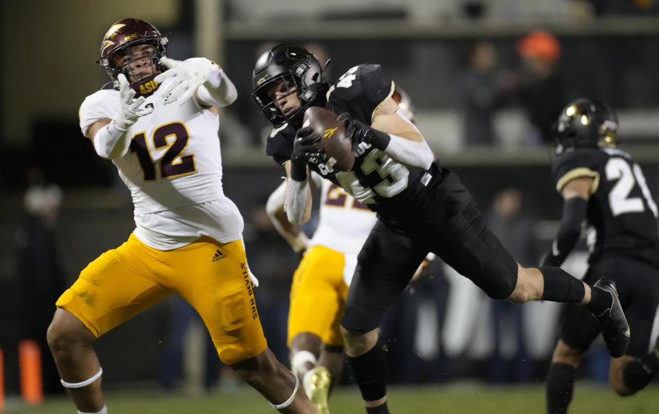 Colorado safety Trevor Woods, right, intercepts a pass intended for Arizona State tight end Jalin Conyers, left, in the second half of an NCAA college football game Saturday, Oct. 29, 2022, in Boulder, Colo. (AP Photo/David Zalubowski)