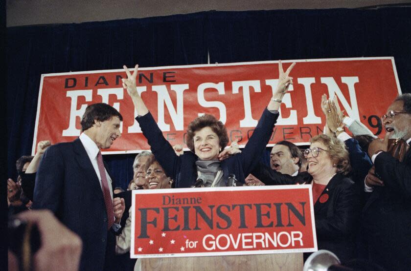 Democratic gubernatorial candidate Dianne Feinstein waves to supporters at the Fairmont Hotel in San Francisco, June 6, 1990 after winning her party's nomination for governor in the California June primary election against John Van de Kamp. At left is her husband Richard Blum. (AP Photo/Paul Sakuma)