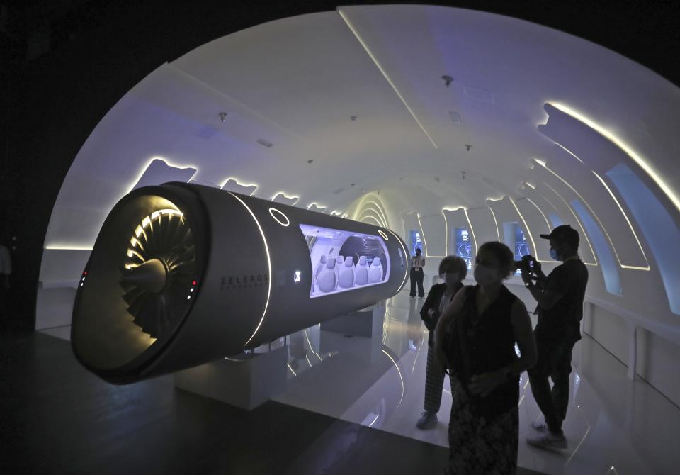 FILE - Zeleros premieres it's hyperloop vehicle at the Spanish Pavilion at the Dubai Expo 2020 in Dubai, United Arab Emirates, Oct. 1, 2021. Intent on making a flawless impression as the first host of the world’s fair in the Middle East, Dubai has spent over $7 billion on pristine fairgrounds and jubilant festivities. But propping up the elaborate fair is the United Arab Emirates’ contentious labor system that long has drawn accusations of mistreatment. (AP Photo/Kamran Jebreili, File)