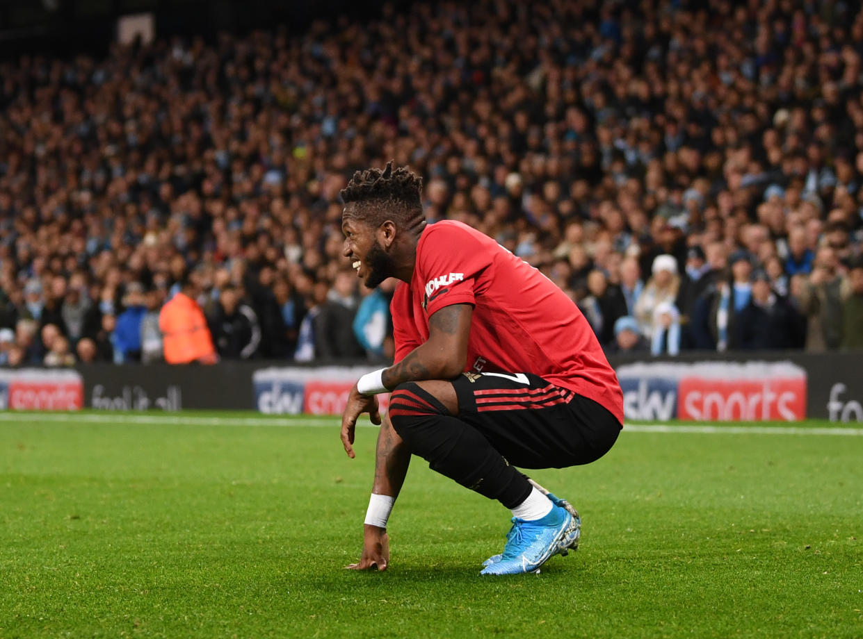 MANCHESTER, ENGLAND - DECEMBER 07: Fred of Manchester United reacts after being hit by a lighter thrown from the crowd during the Premier League match between Manchester City and Manchester United at Etihad Stadium on December 07, 2019 in Manchester, United Kingdom. (Photo by Laurence Griffiths/Getty Images)