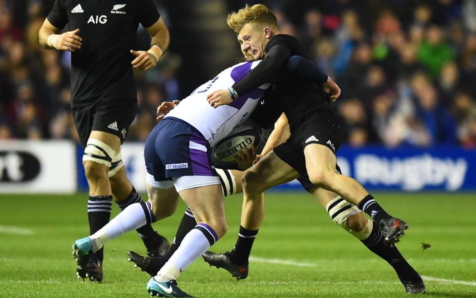 Stuart Hogg clatters into Damian McKenzie - AFP