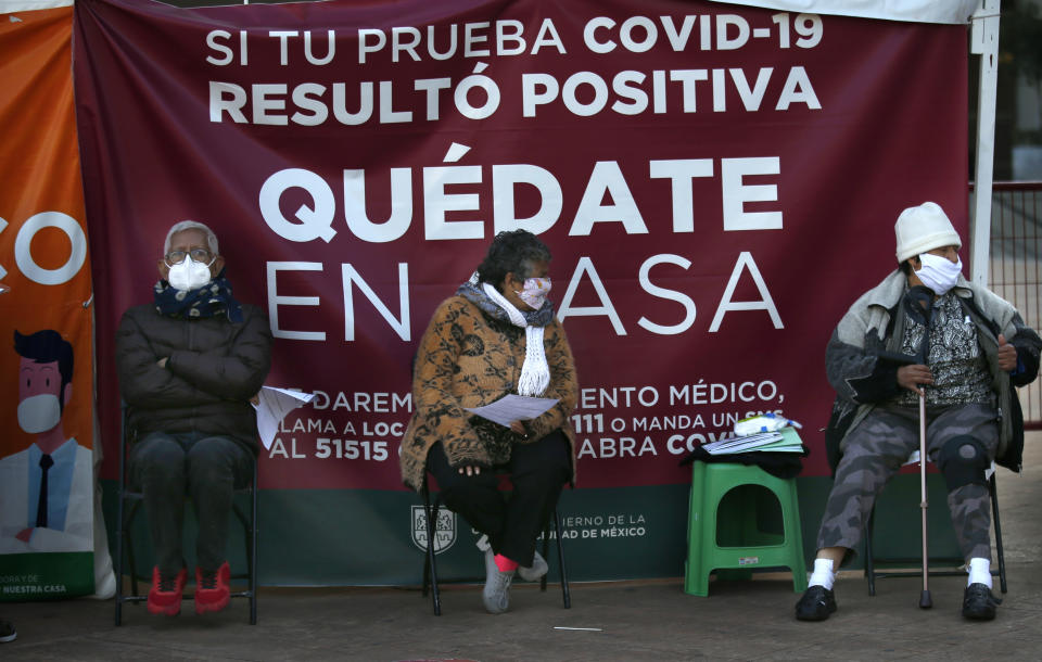 People wait to be tested for the new coronavirus in Mexico City, Wednesday, Jan. 6, 2021. Once Mexico has vaccinated its frontline medical workers against COVID-19, the government will turn its attention to the elderly living in its most remote places, President Andrés Manuel López Obrador said Tuesday. (AP Photo/Marco Ugarte)