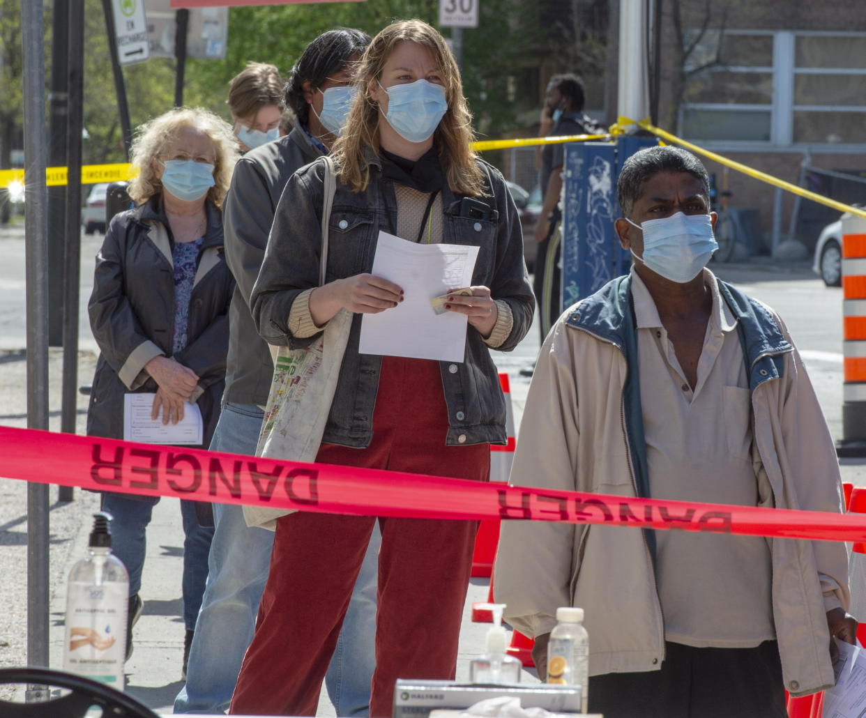 People line up at a mobile COVID-19 testing clinic, Tuesday, May 19, 2020 in Montreal. (Ryan Remiorz/The Canadian Press via AP)