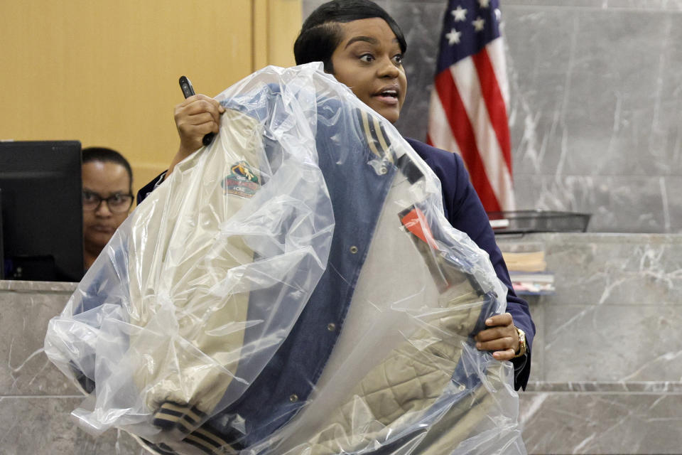 During her closing arguments in the XXXTentacion murder trial, Assistant State Attorney Pascale Achille holds up the jacket worn by the victim at the time of his murder showing an orange marker noting a bullet hole, at the Broward County Courthouse in Fort Lauderdale, Fla., Tuesday, March 7, 2023. Emerging rapper XXXTentacion, born Jahseh Onfroy, 20, was killed during a robbery outside of Riva Motorsports in Pompano Beach in 2018, allegedly by defendants Michael Boatwright, Trayvon Newsome, and Dedrick Williams. (Amy Beth Bennett/South Florida Sun-Sentinel via AP, Pool)