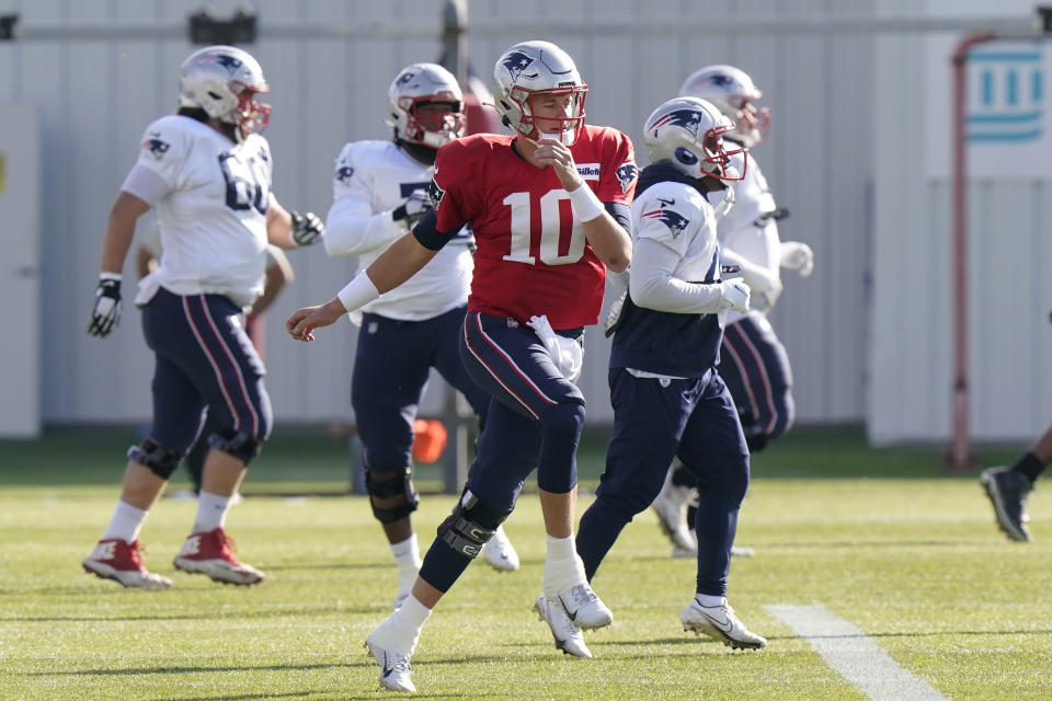 New England Patriots quarterback Mac Jones (10) warms up with teammates during an NFL football practice, Wednesday, Nov. 10, 2021, in Foxborough, Mass. (AP Photo/Steven Senne)