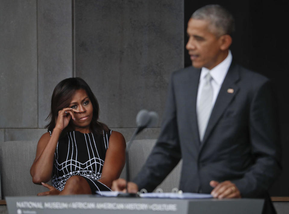 <p>First lady Michelle Obama wipes her eyes as she listens to her husband, President Barack Obama, speak at the dedication ceremony for the Smithsonian Museum of African American History and Culture on the National Mall in Washington, Saturday, Sept. 24, 2016. (AP Photo/Pablo Martinez Monsivais)</p>