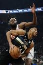 Milwaukee Bucks' Giannis Antetokounmpo is fouled by New York Knicks' Mitchell Robinson during the first half of an NBA basketball game Friday, Jan. 28, 2022, in Milwaukee. (AP Photo/Morry Gash)