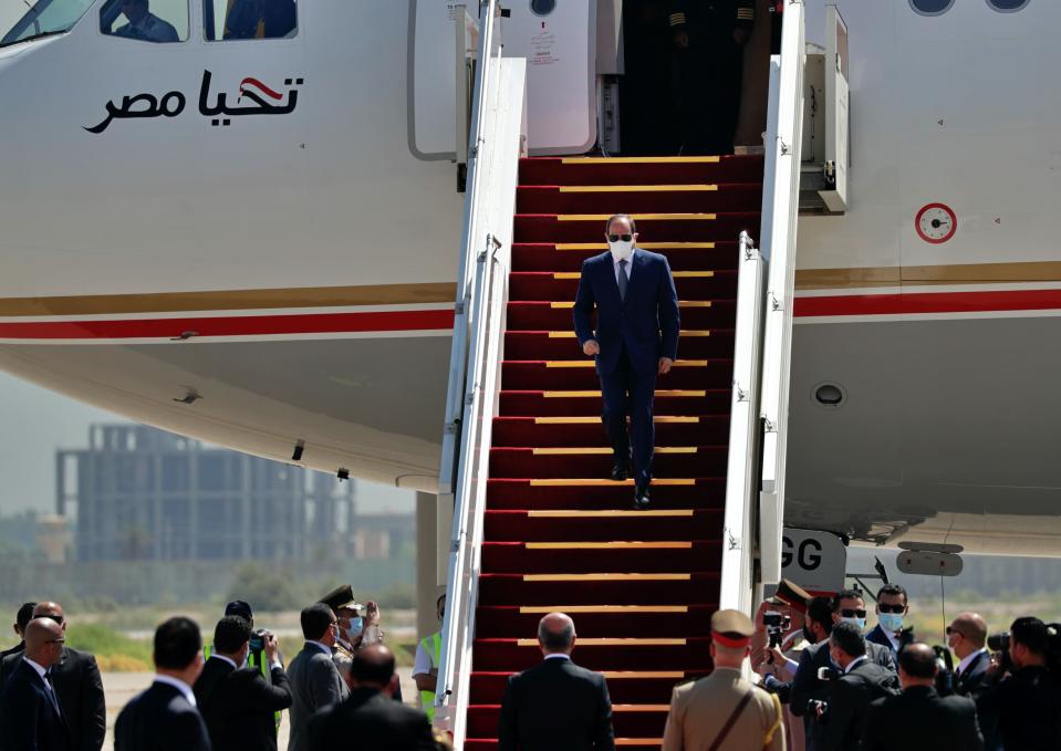 Egyptian President Abdel Fattah el-Sissi, center, arrives at an airport in Baghdad, Iraq, Sunday, June 28, 2021. (AP Photo/Khalid Mohammed)