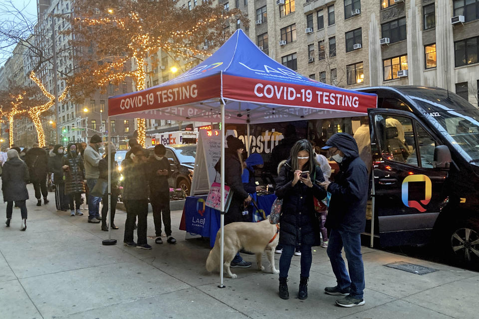 People wait for COVID-19 testing on New York's Upper West Side, Wednesday, Dec. 15, 2021. The new omicron coronavirus mutant speeding around the world may bring another wave of chaos, threatening to further stretch hospital workers already struggling with a surge of delta cases and upend holiday plans for the second year in a row. (AP Photo/Richard Drew)