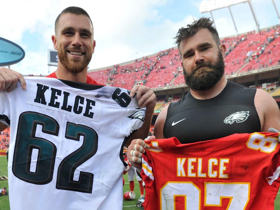 Travis Kelce and Jason Kelce exchange jerseys after playing against each other in 2017.