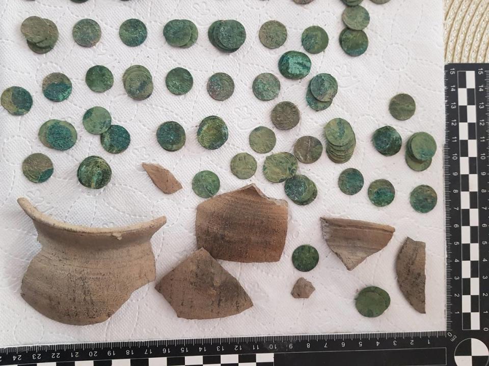 The pottery pieces and some of the coins found in the treasure stash.