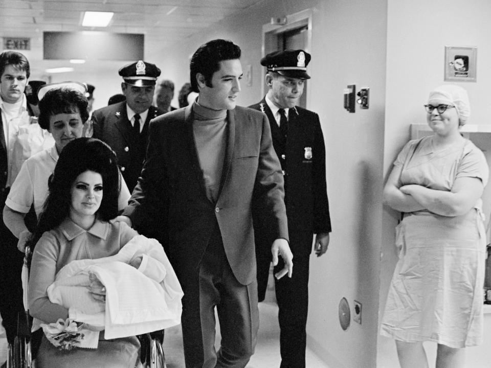 Elvis Presley and his wife, Priscilla, with their new daughter, leave Baptist Hospital in Memphis.