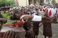 �A man dressed as Jesus Christ is mounted on a cross in front of a Catholic church during a ritual to mark the death of Christ on Good Friday in Nigeria's commercial capital Lagos, in this April 6, 2012 file picture.