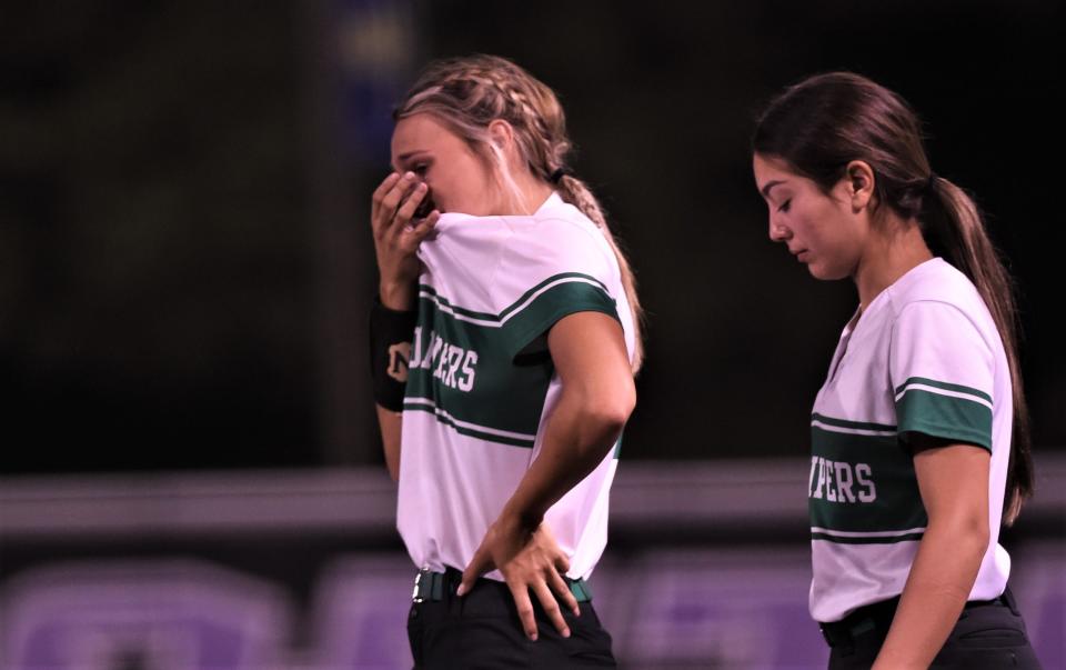 A Hamlin player wipes away tears as the Lady Pipers wait to shake hands with Stamford following their one-game Region I-2A finals playoff Wednesday at ACU's Poly Wells Field.