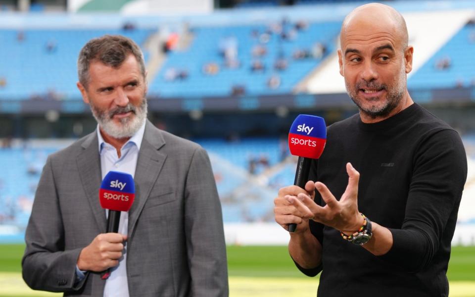 Pep Guardiola, Manager of Manchester City, looks on as they are interviewed by Kelly Cates and Former Manchester United Footballer Roy Keane ahead of the Premier League match between Manchester City and Manchester United at Etihad Stadium on October 02, 2022 in Manchester, England