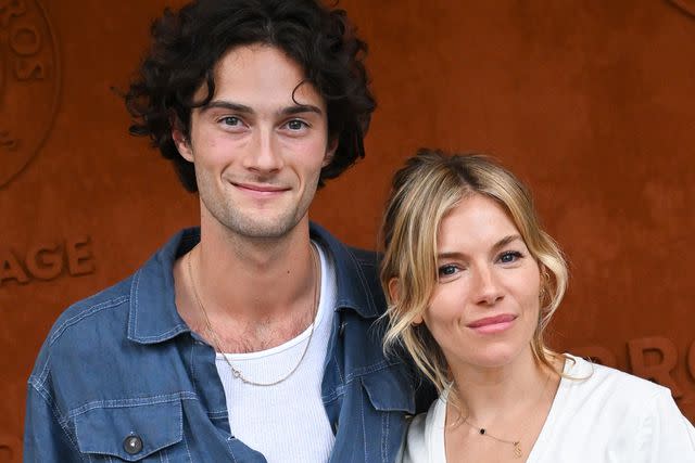 <p>Stephane Cardinale - Corbis/Corbis via Getty</p> Sienna Miller and boyfriend Oli Green attend the 2022 French Open together