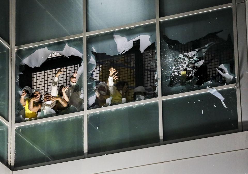 Inmates in a second cell block break windows and chant at the St. Louis Justice Center, known as the city jail, on Sunday, April 4, 2021. Inmates broke windows, set a fire and threw debris to the ground late Sunday at a St. Louis jail that has been plagued by uprisings in recent months. (Colter Peterson/St. Louis Post-Dispatch via AP)