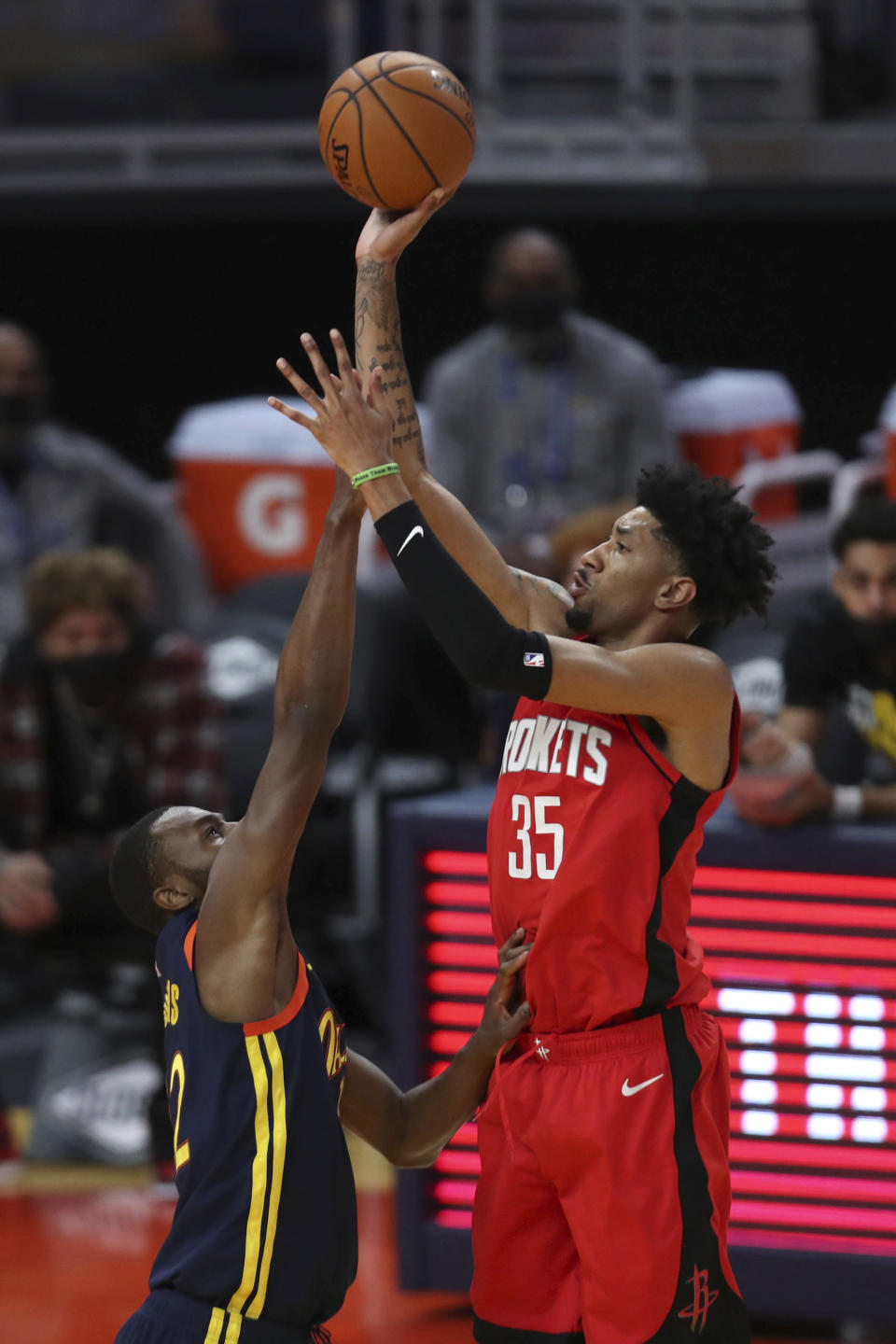 Houston Rockets center Christian Wood, right, shoots over Golden State Warriors forward Andrew Wiggins during the second half of an NBA basketball game in San Francisco, Saturday, April 10, 2021. (AP Photo/Jed Jacobsohn)