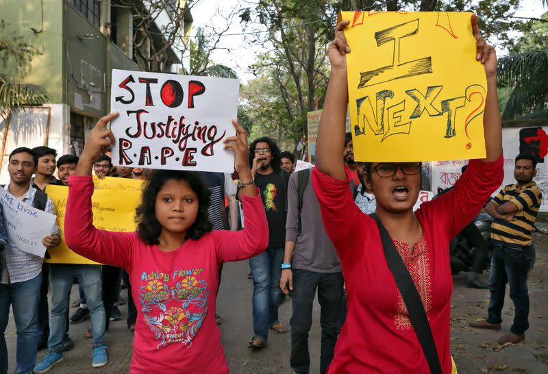 Students shout slogans as they display placards during a protest against the alleged rape and murder of a 27-year-old woman, in Kolkata