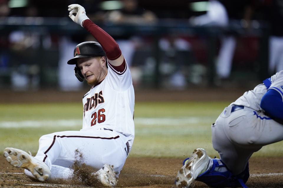 Arizona Diamondbacks' Pavin Smith scores a run against the Kansas City Royals during the fourth inning of a baseball game Monday, May 23, 2022, in Phoenix. (AP Photo/Ross D. Franklin)