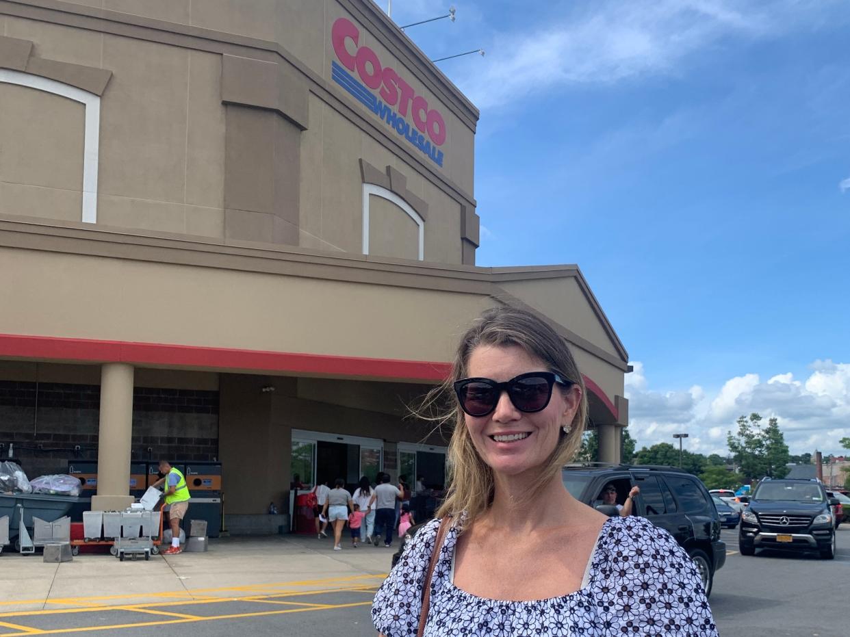 Janine in blue and white blouse in front of costco