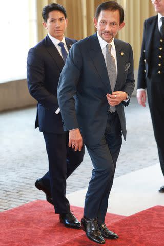 <p>Chris Jackson/Getty </p> Prince Abdul Mateen and Sultan of Brunei Hassanal Bolkiah at a Buckingham Palace reception before the coronation of King Charles and Queen Camilla in May 2023.