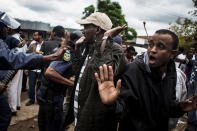 <p>Police push away members of the Somalian community as an anti-immigrant march turns violent in Pretoria, South Africa, Feb. 24, 2017. Police fired rubber bullets, tear gas and stun grenades to break up violent clashes between local protesters and migrants. (Photo: John Wessels/AFP/Getty Images) </p>