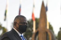 U.S. Defense Secretary Lloyd Austin walks with Romanian Defense Minister Nicolae Ciuca during a welcoming ceremony in Bucharest, Romania, Wednesday, Oct. 20, 2021. Austin is visiting Romania before attending the NATO Defense Ministerial in Brussels. (AP Photo/Andreea Alexandru)