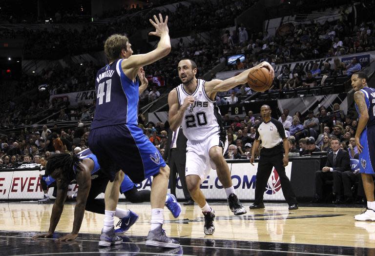 Manu Ginobili of the San Antonio Spurs drives around Dirk Nowitzki of the Dallas Mavericks in Game Two of the Western Conference Quarterfinals at the AT&T Center on April 23, 2014