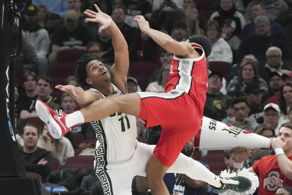 Michigan State's A.J. Hoggard (11) collides with Ohio State's Roddy Gayle Jr. (1) during the second half of an NCAA college basketball game at the Big Ten men's tournament, Friday, March 10, 2023, in Chicago. (AP Photo/Erin Hooley)