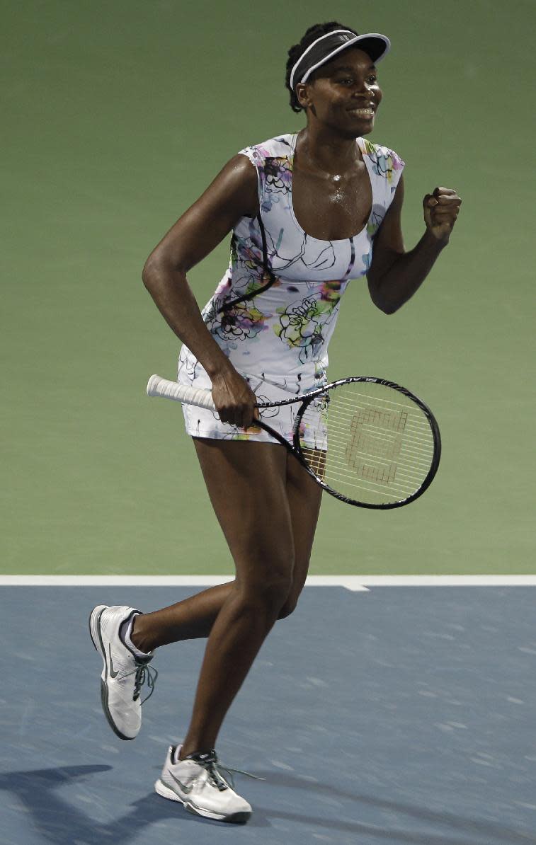 Venus Williams of the U.S. celebrates after she beats Caroline Wozniacki of Denmark during a semi final match of Dubai Duty Free Tennis Championships in Dubai, United Arab Emirates, Friday, Feb. 21, 2014. (AP Photo/Kamran Jebreili)