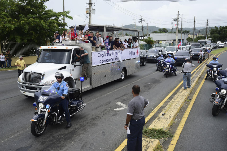 Boston Red Sox manager Alex Cora arrives at his hometown with the 2018 World Series trophy, accompanied by Chairman Tom Werner and President and CEO Sam Kennedy, as well as seven Red Sox players and coaches, in Caguas, Puerto Rico, Saturday, Nov. 3, 2018. (AP Photo Carlos Giusti)