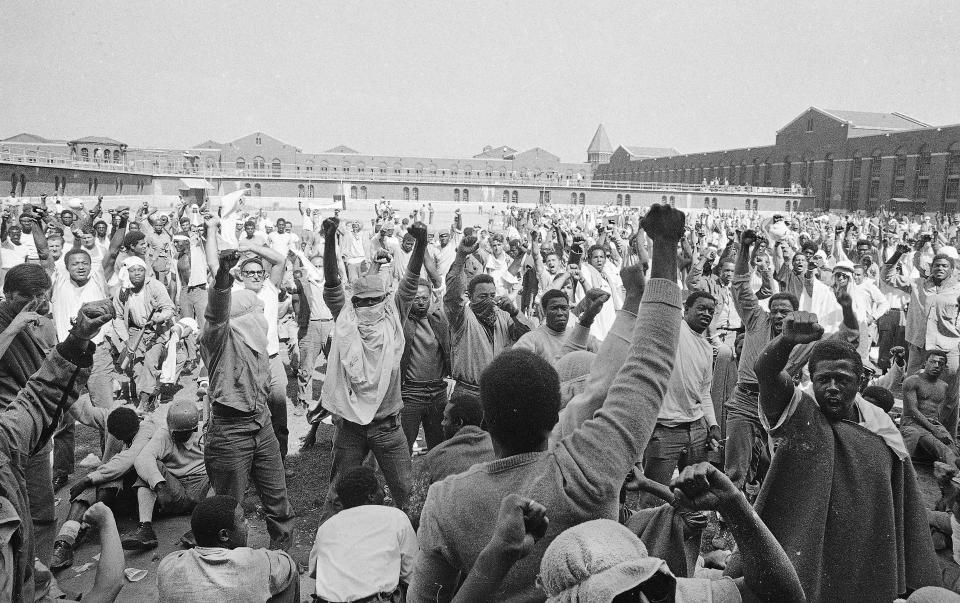 Inmates at New York's Attica state prison protest in September 1971. The riot in western New York began that Sept. 9. The prisoners took 42 officers and civilian prison employees hostage. After four days of negotiations, the New York State Police retook the prison by force, fatally shooting 29 inmates and 10 hostages. Three inmates and a prison guard were killed by inmates in the days before the retaking. In all, the event ended in 43 deaths.