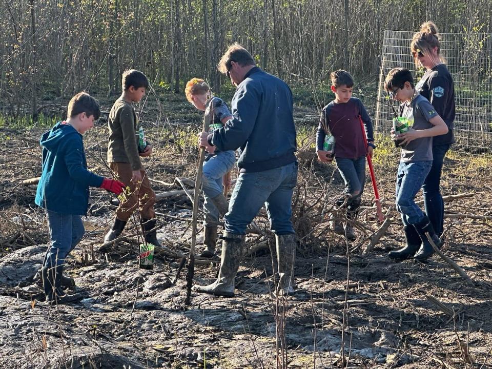 Scout members of Troop 71 from Shreve were among the seven troops on hand Monday in Millersburg taking part in tree planting along the Holmes County Trail at the dedication ceremony for the completion of the H2Ohio wetlands project at the Killbuck Creek and Sand Run.