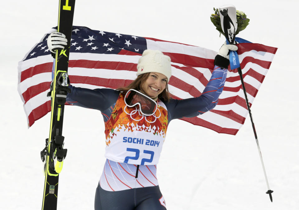 Women's supercombined bronze medalist United States' Julia Mancuso poses with the U.S. flag after a flower ceremony at the Alpine ski venue in the Sochi 2014 Winter Olympics, Monday, Feb. 10, 2014, in Krasnaya Polyana, Russia.(AP Photo/Charles Krupa)