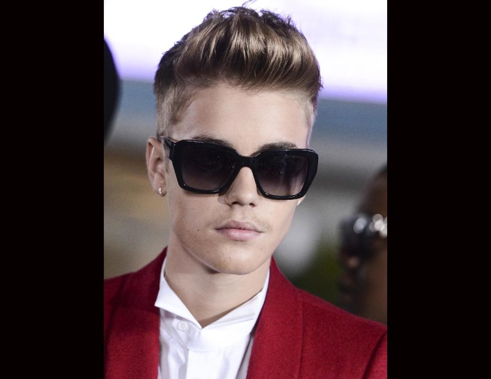 FILE - Singer Justin Bieber arrives at the premiere of the feature film "Justin Bieber's Believe" at Regal Cinemas L.A. Live on in this Dec. 18, 2013 file photo taken in Los Angeles. Bieber has been arrested Thursday Jan 23, 2014 and is accused of DUI and drag racing according to the Miami Beach Police Department. (Photo by Dan Steinberg/Invision/AP, FILE)