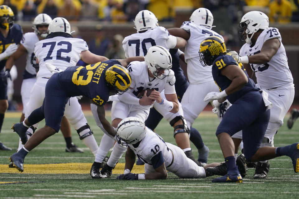 Michigan linebacker Michael Barrett (23) sacks Penn State quarterback Drew Allar (15) in the second half of an NCAA college football game in Ann Arbor, Mich., Saturday, Oct. 15, 2022. (AP Photo/Paul Sancya)