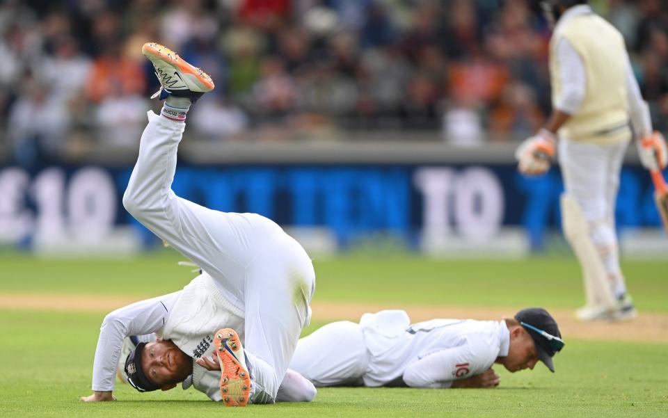 England fielder Jonny Bairstow takes a tumble whilst making a stop in the slips as Ollie Pope looks on during day one of the 5th Test match between England and India at Edgbaston on July 01, 2022 in Birmingham, England - Stu Forster/Getty Images Europe
