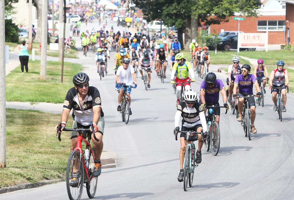 Cyclists ride up a hill outside Colfax on the way to Tama-Toledo Thursday on Day 5 of RAGBRAI 50.