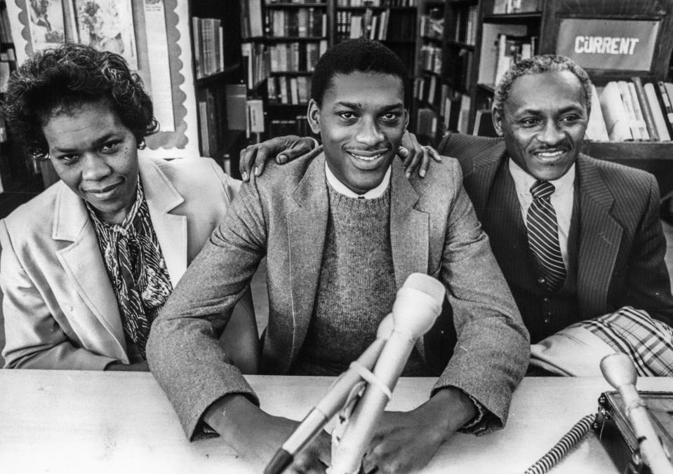 Third team Parade Basketball All American Patrick Ford (Cass Tech, Class of 1982) with his parents in the Cass Tech library as he announced that he would be attending Michigan State University.