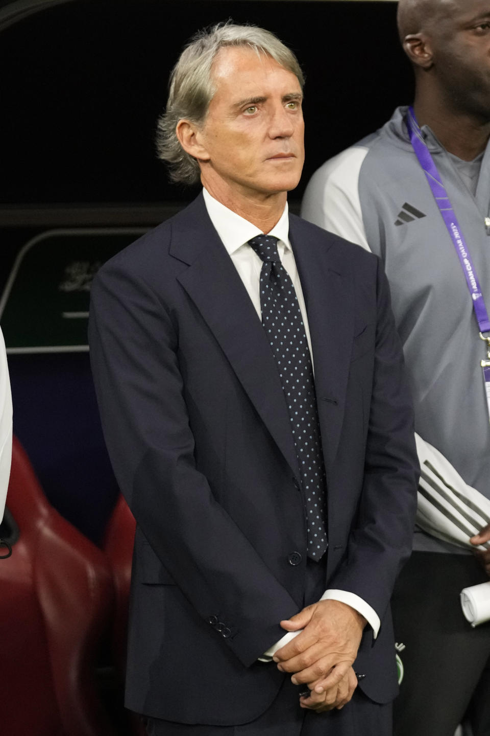 Saudi Arabia's head coach Roberto Mancini stands on the bench ahead of the Asian Cup Group F soccer match between Saudi Arabia and Oman at Khalifa International Stadium in Doha, Qatar, Tuesday, Jan. 16, 2024. (AP Photo/Aijaz Rahi)