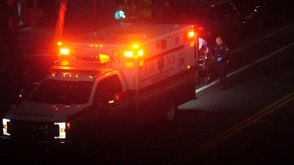 In this Thursday, April 2, 2020, image made from video, a person is taken into an ambulance in the Brooklyn borough of New York. The sounds of sirens can be heard prominently in the city, where the number of deaths due to the new coronavirus continues to climb. (AP Photo/Emily Leshner)
