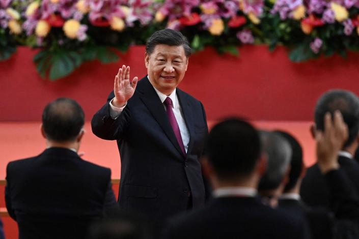 TOPSHOT - China's President Xi Jinping waves following his speech after a ceremony to inaugurate the city's new leader and government in Hong Kong on July 1, 2022, on the 25th anniversary of the city's handover from Britain to China. (Photo by Selim CHTAYTI / POOL / AFP) (Photo by SELIM CHTAYTI/POOL/AFP via Getty Images) ORIG FILE ID: AFP_32DL269.jpg