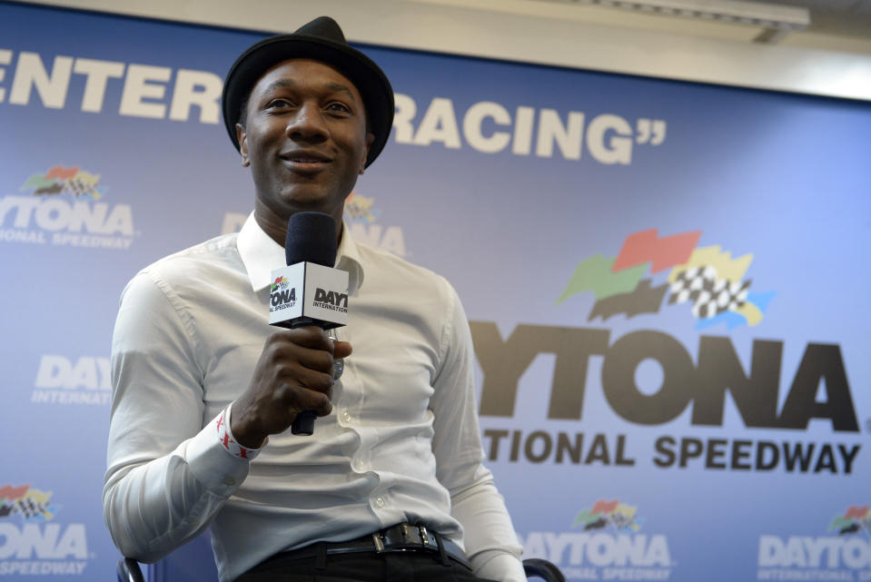 Singer Aloe Blacc answers a question during a news conference before the NASCAR Daytona 500 Sprint Cup series auto race at Daytona International Speedway in Daytona Beach, Fla., Sunday, Feb. 23, 2014. (AP Photo/Phelan M. Ebenhack)