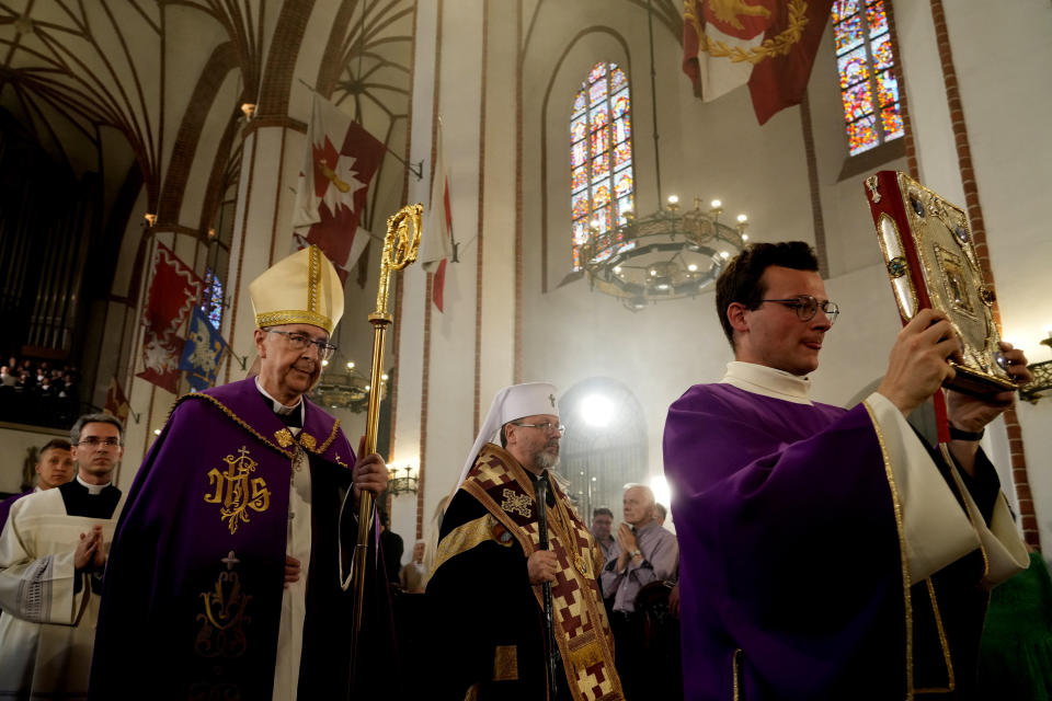 The head of Poland's Roman Catholic Church, Archbishop Stanislaw Gadecki, left, and Archbishop Sviatoslav Shevchuk, second right, of the Ukrainian Greek Catholic Church hold a reconciliation religious service as part of observances honoring some 100,000 Poles murdered by Ukrainian nationalists in 1943-44, at St. John's cathedral in Warsaw, Poland, on Friday, July 7, 2023. (AP Photo/Czarek Sokolowski)