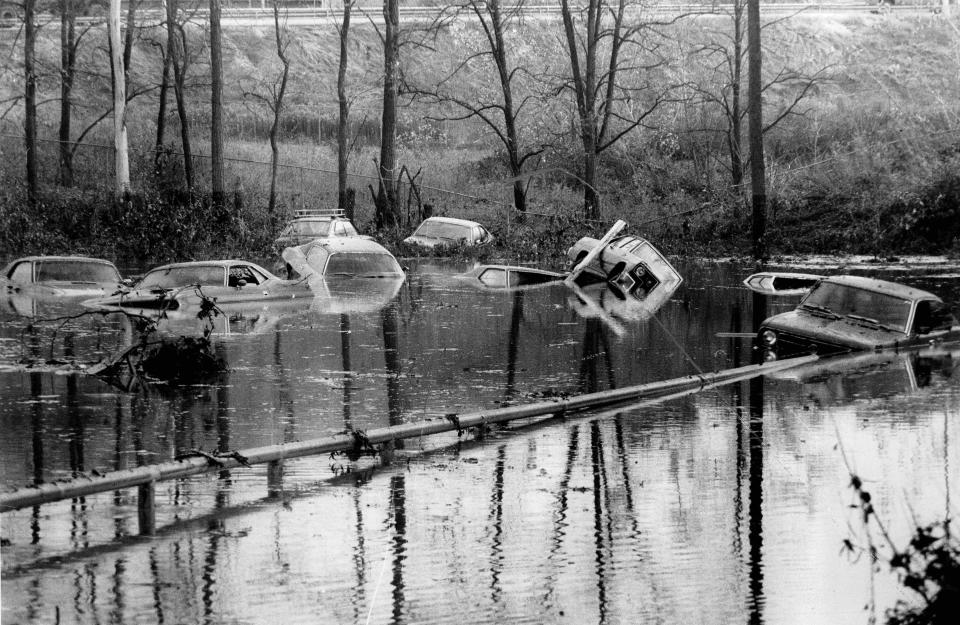 Floodwaters carry along cars during a 1974 disaster after more than 100 million gallons of water surged through a hole in the Erie Canal in Bushnell's Basin. The disaster was blamed on a contractor installing a sewer line beneath the canal.