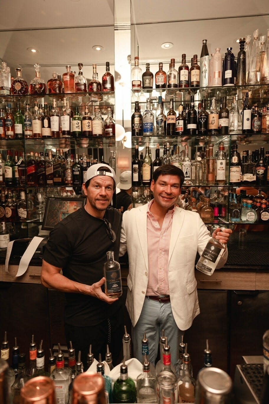 Mark Wahlberg and Flecha Azul Tequila co-founder Aron Marquez behind the bar at Bice Palm Beach on Saturday.