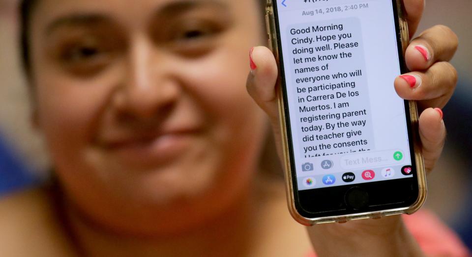 Cindy Martinez shows one of the texts she received alerting her of her children's activities at El Hogar del Niño, a Head Start center on South Loomis Street in Chicago.